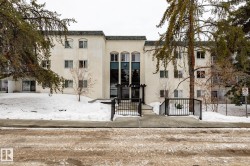 Snow covered property featuring a view of apartment building / complex - 