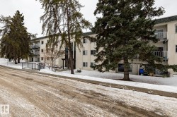 Snow covered building with a view of apartment building / complex - 