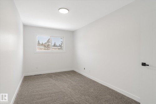 Spare room featuring carpet and baseboards - 5105 106A Street, Edmonton, AB - Indoor Photo Showing Other Room