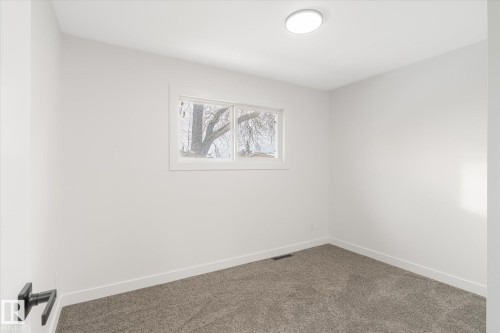Empty room featuring baseboards and carpet flooring - 5105 106A Street, Edmonton, AB - Indoor Photo Showing Other Room
