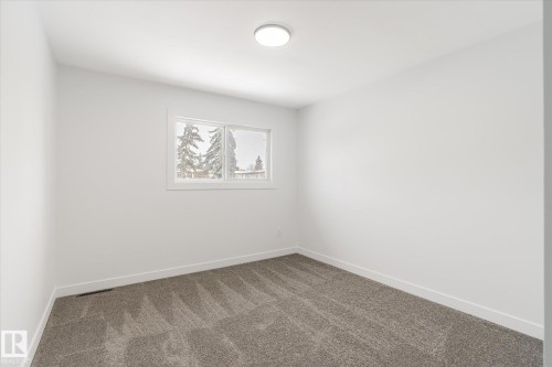 Carpeted spare room with baseboards - 5105 106A Street, Edmonton, AB - Indoor Photo Showing Other Room