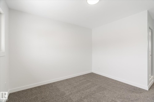 Spare room with baseboards and carpet - 5105 106A Street, Edmonton, AB - Indoor Photo Showing Other Room