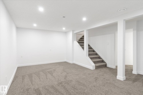 Finished basement featuring carpet floors, stairs, and recessed lighting - 5105 106A Street, Edmonton, AB - Indoor