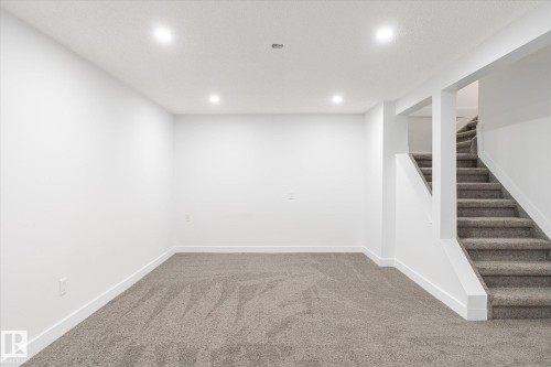 Finished basement featuring carpet, stairs, recessed lighting, and a textured ceiling - 5105 106A Street, Edmonton, AB - Indoor Photo Showing Other Room