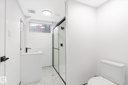 Bathroom featuring a shower stall, vanity, and light marble finish flooring - 5105 106A Street, Edmonton, AB - Indoor Photo Showing Bathroom