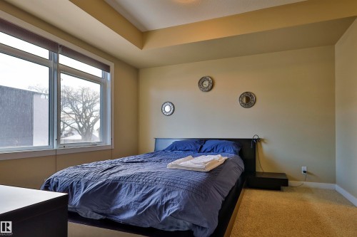 Carpeted bedroom featuring baseboards - 203 9908 84 Avenue, Edmonton, AB - Indoor Photo Showing Bedroom