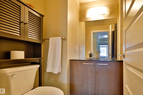 Half bath featuring vanity and toilet - 203 9908 84 Avenue, Edmonton, AB - Indoor Photo Showing Bathroom