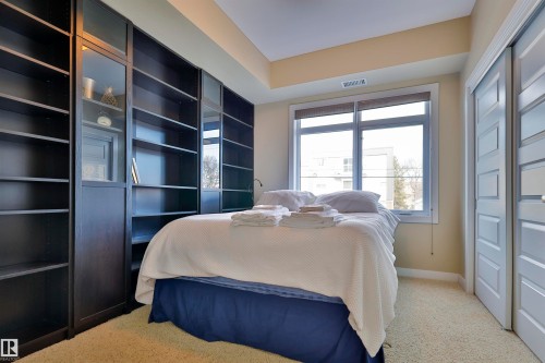 Bedroom with light carpet and a closet - 203 9908 84 Avenue, Edmonton, AB - Indoor Photo Showing Bedroom