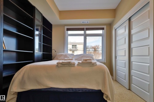 Bedroom featuring a closet and carpet flooring - 203 9908 84 Avenue, Edmonton, AB - Indoor Photo Showing Bedroom