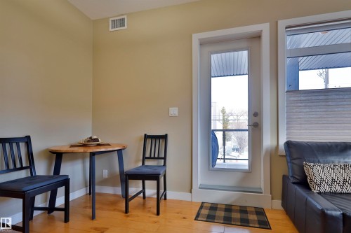 Sitting room featuring baseboards and light wood finished floors - 203 9908 84 Avenue, Edmonton, AB - Indoor