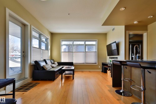 Living room featuring light wood-style flooring - 203 9908 84 Avenue, Edmonton, AB - Indoor