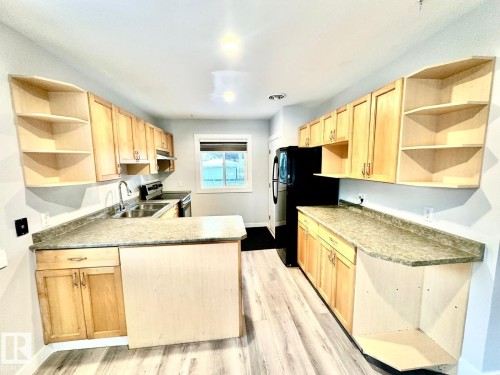 A 9232 75 Street, Edmonton, AB - Indoor Photo Showing Kitchen With Double Sink