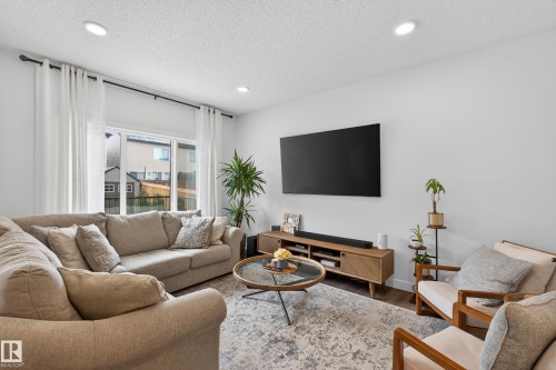 Living area with wood finished floors, recessed lighting, and a textured ceiling - 2098 Graydon Hill Crescent, Edmonton, AB - Indoor Photo Showing Living Room
