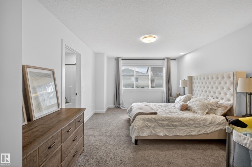 Carpeted bedroom with a textured ceiling and baseboards - 2098 Graydon Hill Crescent, Edmonton, AB - Indoor Photo Showing Bedroom