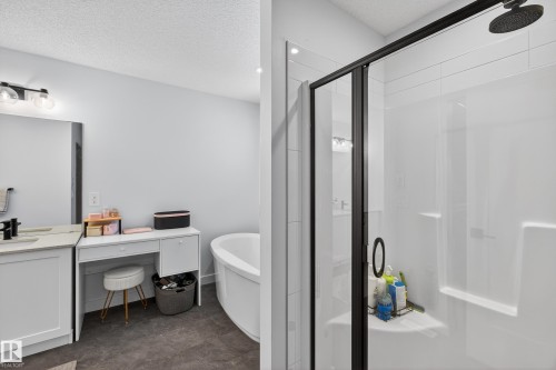 Bathroom with a stall shower, vanity, a freestanding tub, and a textured ceiling - 2098 Graydon Hill Crescent, Edmonton, AB - Indoor Photo Showing Bathroom