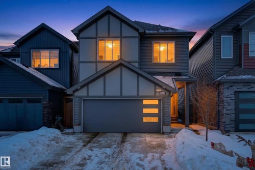 View of front of property featuring concrete driveway, board and batten siding, roof with shingles, and a garage - 2098 Graydon Hill Crescent, Edmonton, AB - Outdoor