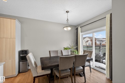 Dining space with a textured ceiling and light wood-style floors - 5910 Anthony Crescent, Edmonton, AB - Indoor Photo Showing Dining Room
