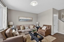 Living room featuring dark wood-style floors and a textured ceiling - 
