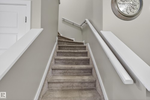 Staircase with carpet flooring and baseboards - 5910 Anthony Crescent, Edmonton, AB - Indoor Photo Showing Other Room