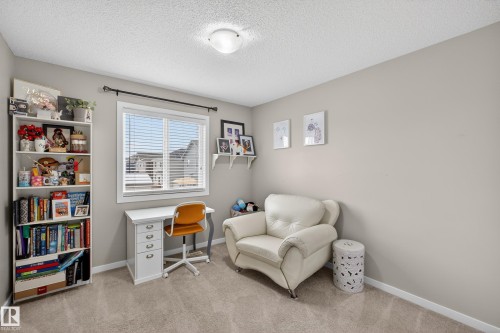 Sitting room with a textured ceiling and light colored carpet - 5910 Anthony Crescent, Edmonton, AB - Indoor