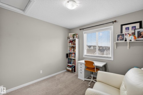 Home office featuring light colored carpet and a textured ceiling - 5910 Anthony Crescent, Edmonton, AB - Indoor