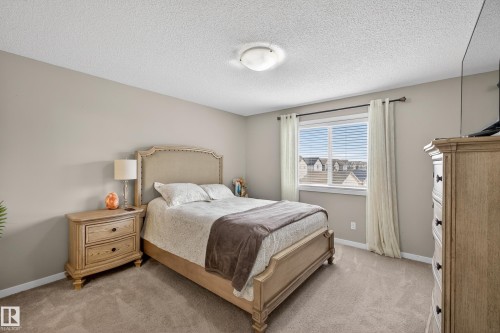 Bedroom with a textured ceiling and light carpet - 5910 Anthony Crescent, Edmonton, AB - Indoor Photo Showing Bedroom