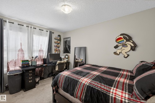 Bedroom with light colored carpet and a textured ceiling - 5910 Anthony Crescent, Edmonton, AB - Indoor Photo Showing Bedroom