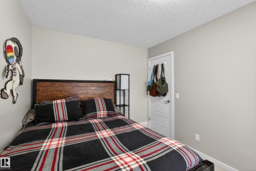 Bedroom with a textured ceiling and carpet flooring - 5910 Anthony Crescent, Edmonton, AB - Indoor Photo Showing Bedroom