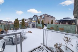 Fenced backyard featuring a shed, a residential view, a gazebo, and a deck - 
