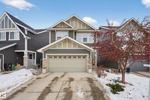 Craftsman inspired home with board and batten siding, stone siding, and driveway - 5910 Anthony Crescent, Edmonton, AB - Outdoor With Facade