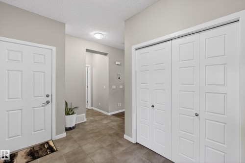 Foyer with a textured ceiling and baseboards - 5910 Anthony Crescent, Edmonton, AB - Indoor Photo Showing Other Room