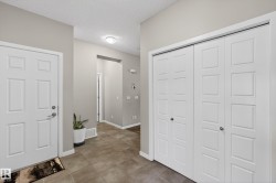 Foyer with a textured ceiling and baseboards - 
