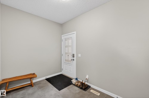 Doorway to outside featuring a textured ceiling and tile patterned flooring - 5910 Anthony Crescent, Edmonton, AB - Indoor Photo Showing Other Room