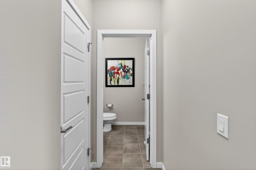 Bathroom with toilet and light tile patterned floors - 5910 Anthony Crescent, Edmonton, AB - Indoor Photo Showing Bathroom