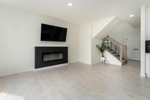 112 Bluff Cove, Leduc, AB - Indoor Photo Showing Living Room With Fireplace