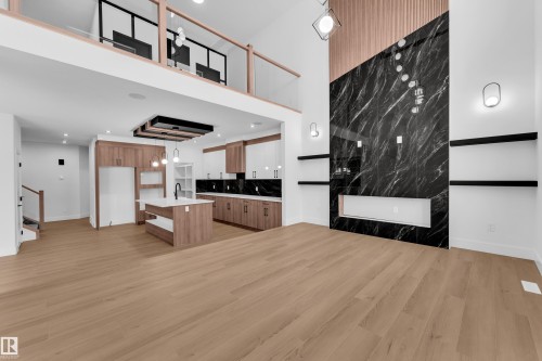 Unfurnished living room featuring light wood-type flooring and a high ceiling - 733 Astoria Way, Devon, AB - Indoor Photo Showing Other Room