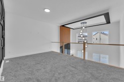 Empty room with carpet flooring and hanging lights - 