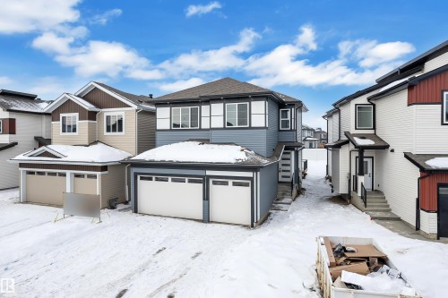 View of front of home featuring a residential view and an attached garage - 733 Astoria Way, Devon, AB - Outdoor