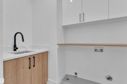 Laundry room featuring cabinet space, tile patterned flooring, and washer hookup - 