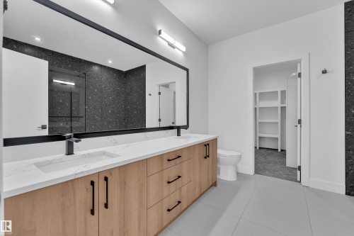 Bathroom with a shower stall, double vanity, light tile patterned flooring, and a walk in closet - 733 Astoria Way, Devon, AB - Indoor Photo Showing Bathroom