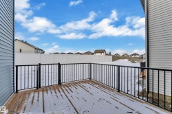 Snow covered deck with a residential view - 