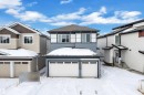 View of front of house featuring an attached garage and a shingled roof - 733 Astoria Way, Devon, AB  - Outdoor 