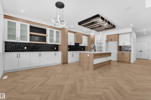 Two tone kitchen with open shelves, decorative light fixtures, parquet flooring, an island with sink, and two tone cabinetry - 737 Astoria Way, Devon, AB - Indoor Photo Showing Kitchen