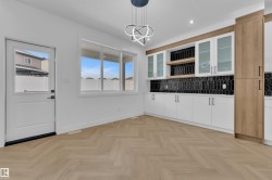 Bar area with pendant lighting, two tone cabinets, open shelves, glass insert cabinets, and parquet flooring - 