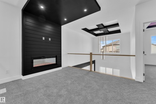 Unfurnished living room featuring carpet floors, a large fireplace, and recessed lighting - 737 Astoria Way, Devon, AB - Indoor With Fireplace