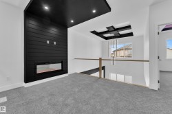 Unfurnished living room featuring carpet floors, a large fireplace, and recessed lighting - 