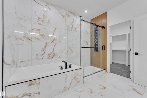 Bathroom featuring a garden tub, a marble finish shower, marble look tile flooring, a spacious closet, and recessed lighting - 737 Astoria Way, Devon, AB - Indoor Photo Showing Bathroom