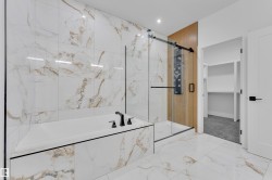 Bathroom featuring a garden tub, a marble finish shower, marble look tile flooring, a spacious closet, and recessed lighting - 