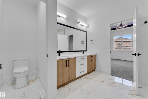 Bathroom with light marble finish floors and double vanity - 737 Astoria Way, Devon, AB - Indoor Photo Showing Bathroom