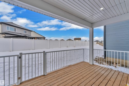 Wooden deck with a residential view - 737 Astoria Way, Devon, AB - Outdoor With Exterior